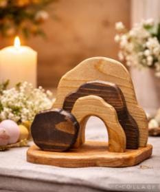 Wooden sculpture on a stand with candles and flowers in the background