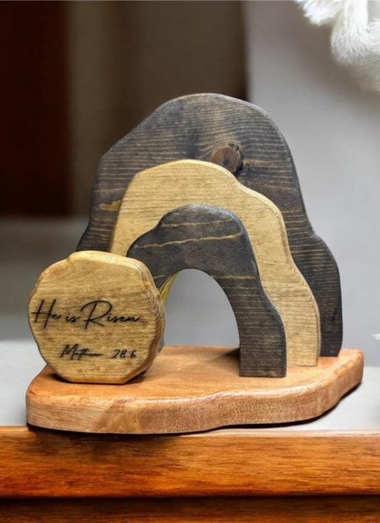 Wooden decorative item with engraved text on a wooden surface