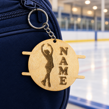 Figure skating keychain, raised-arm pose, by the rink